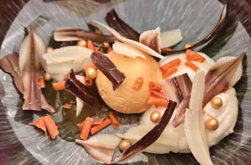 Mousse iz bele čokolade s pomarančnim sladoledom in naribano belo in črno čokolado.